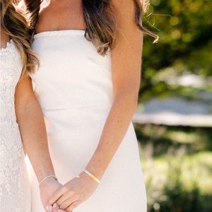 White gown with beaded rim.